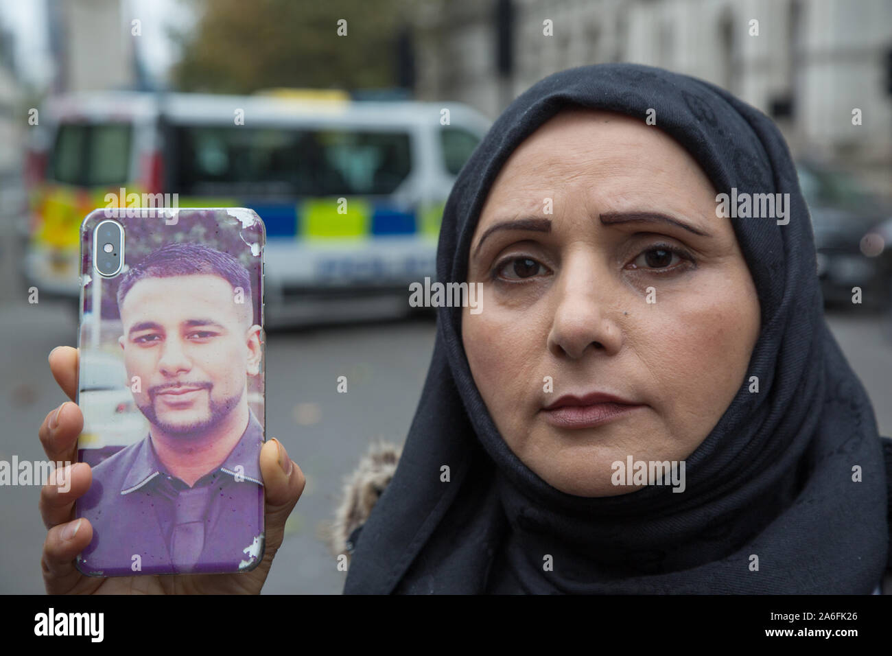 London UK 28th Oct 2019 Mohammed Yassar mother holds a pictture of her son who was shot dead by West Yorkshire Police. Families of those who have suff Stock Photo