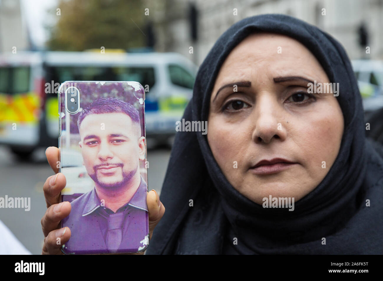 London UK 28th Oct 2019 Mohammed Yassar mother holds a pictture of her son who was shot dead by West Yorkshire Police. Families of those who have suff Stock Photo