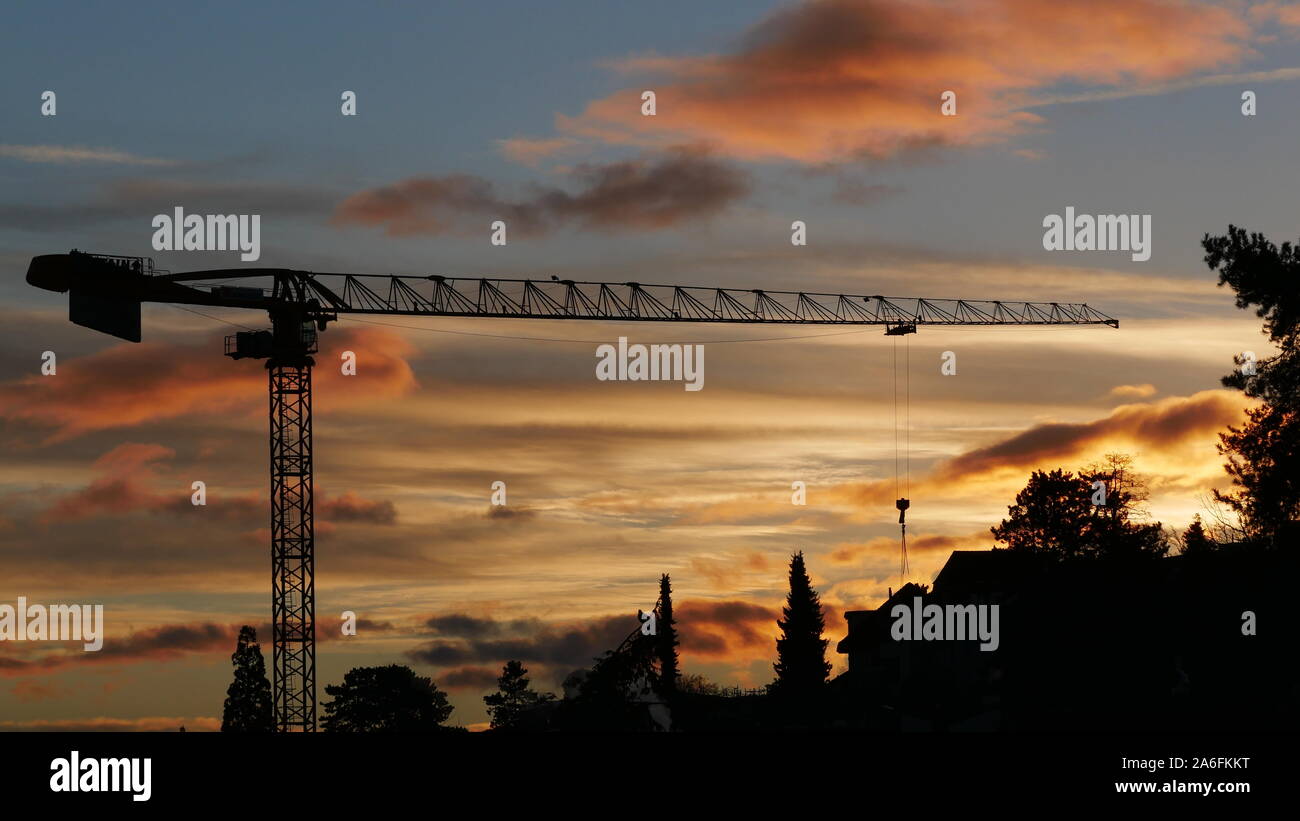 Construction crane in the light of the sunrise Stock Photo