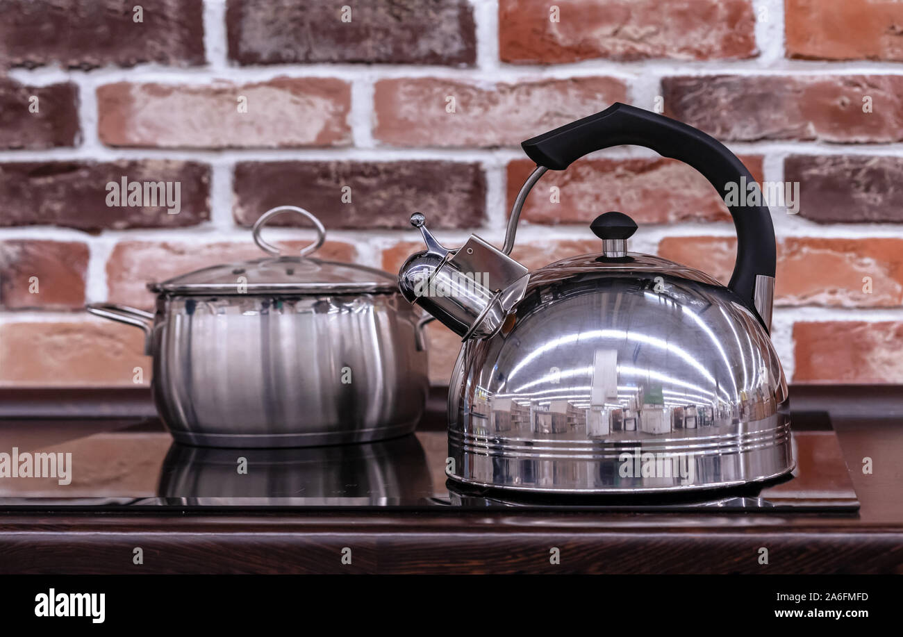 Metal kettle with a whistle on an induction stove Stock Photo Alamy