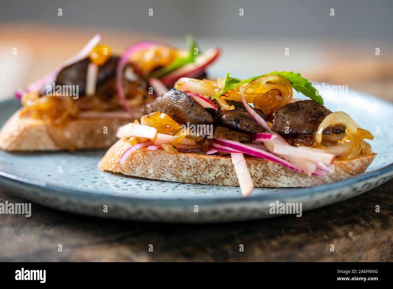 Chicken liver with apple, onion and mango chutney on toast Stock Photo