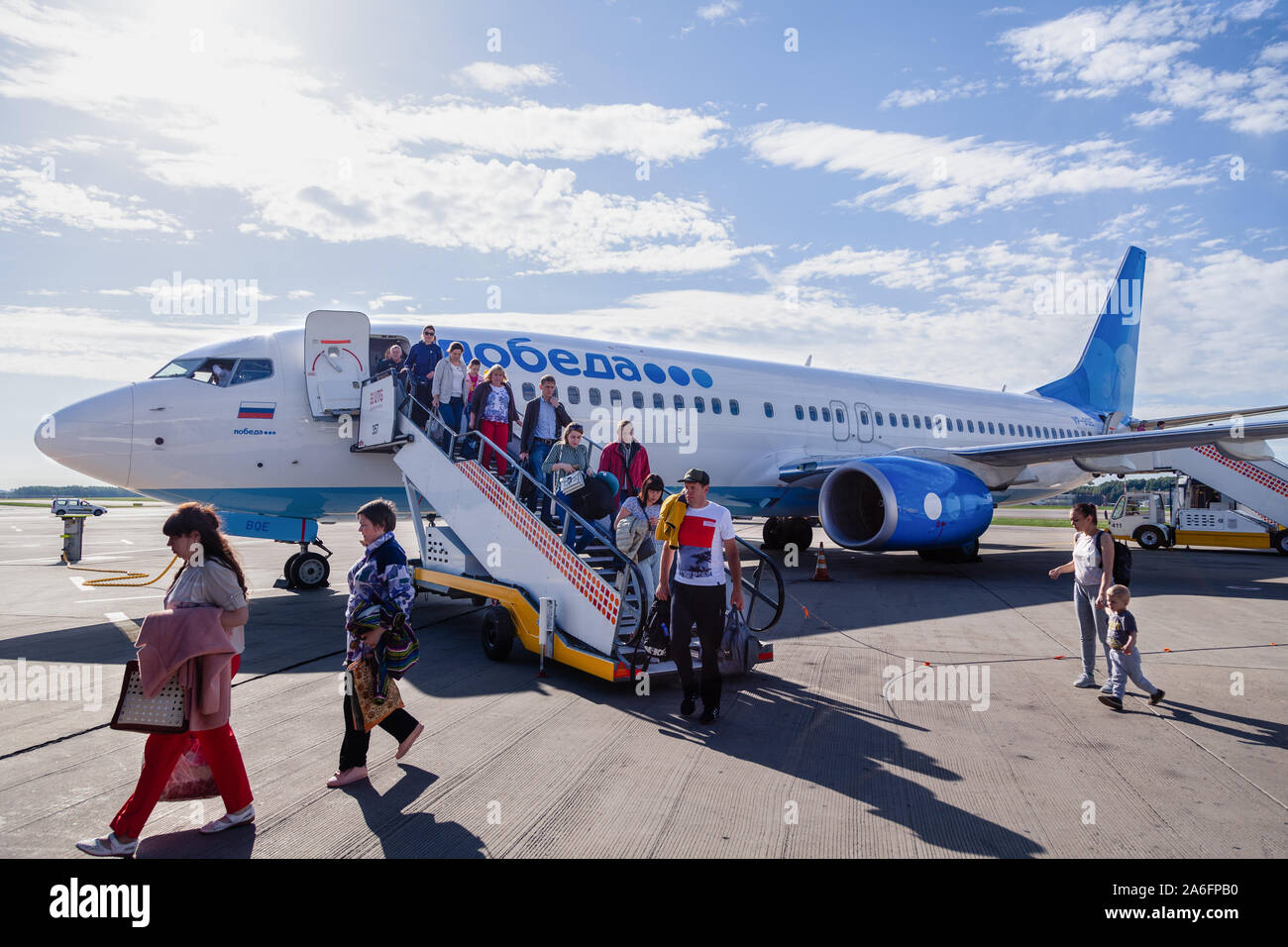 Russia Moscow 2019-06-17 Passengers of Boeing 737 Pobeda Airlines russian company low cost price comes off plane to airfield by trap. Concept travel b Stock Photo
