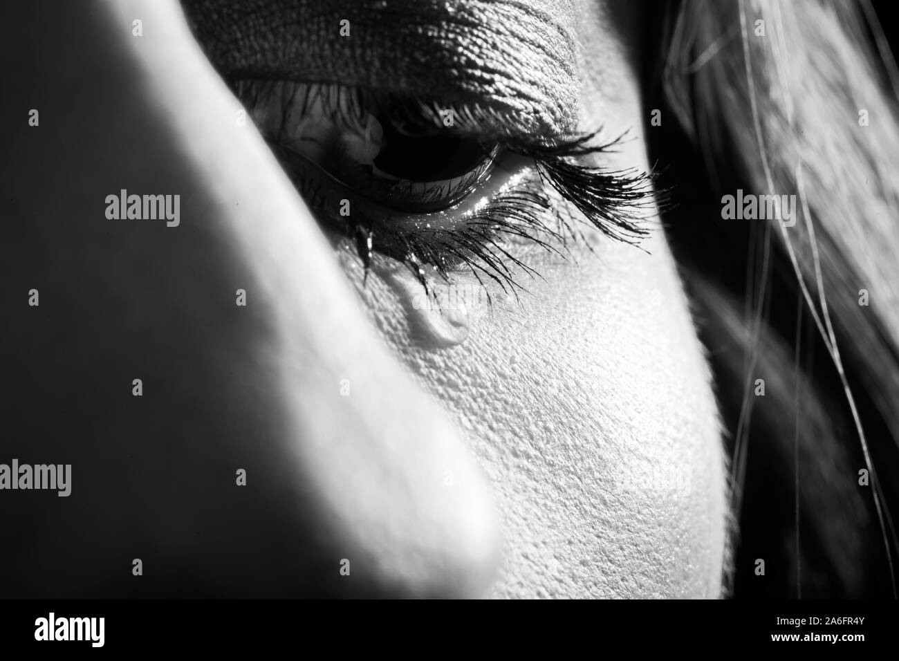 sad woman crying, tear on eye closeup portrait, monochrome Stock Photo