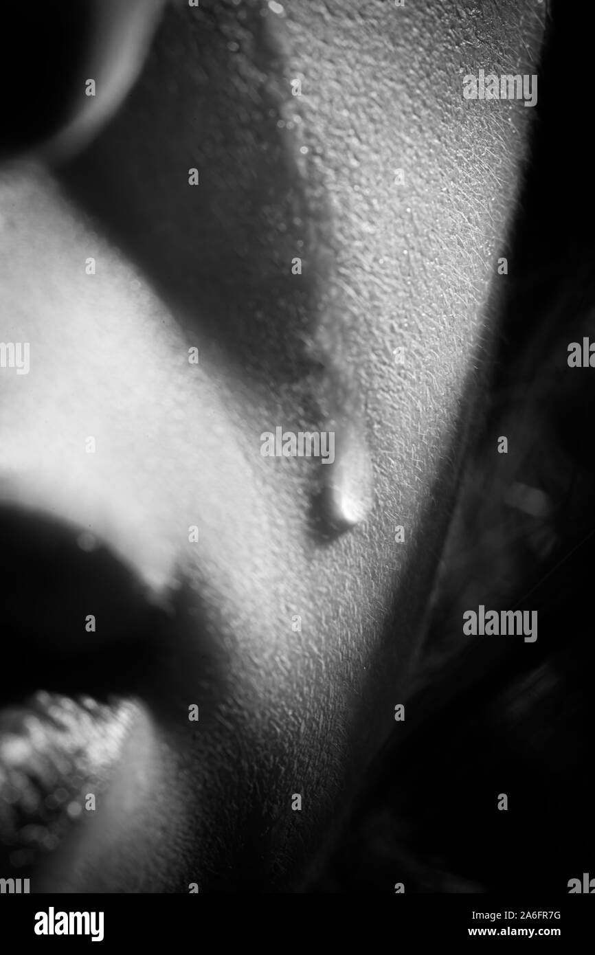 sad woman crying, tear on cheek closeup portrait, monochrome Stock Photo