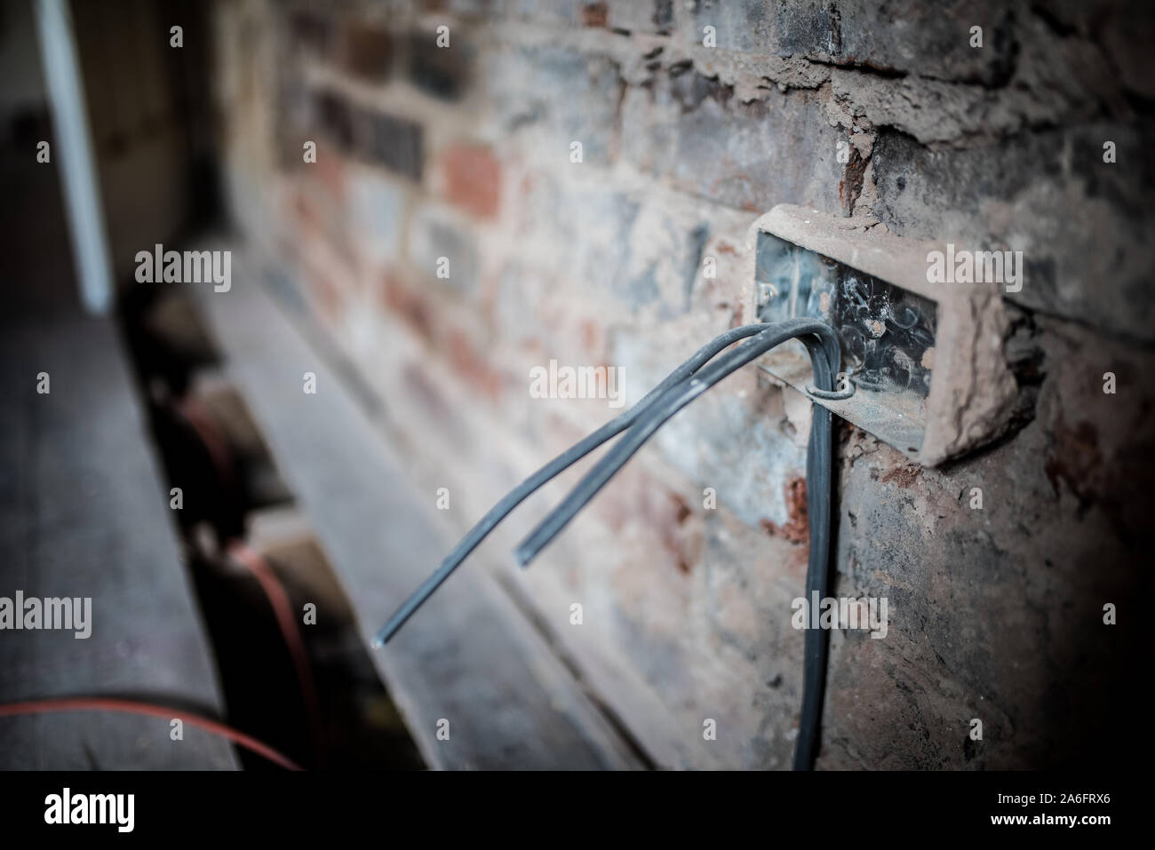 An electrician wires in the 1st fix of an electrical installation