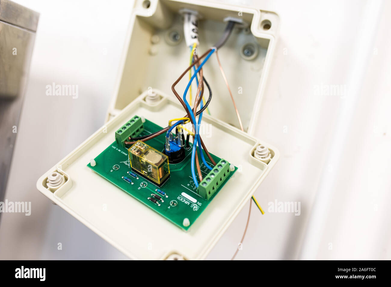 An electrician wiring in an alarm for security and remote access