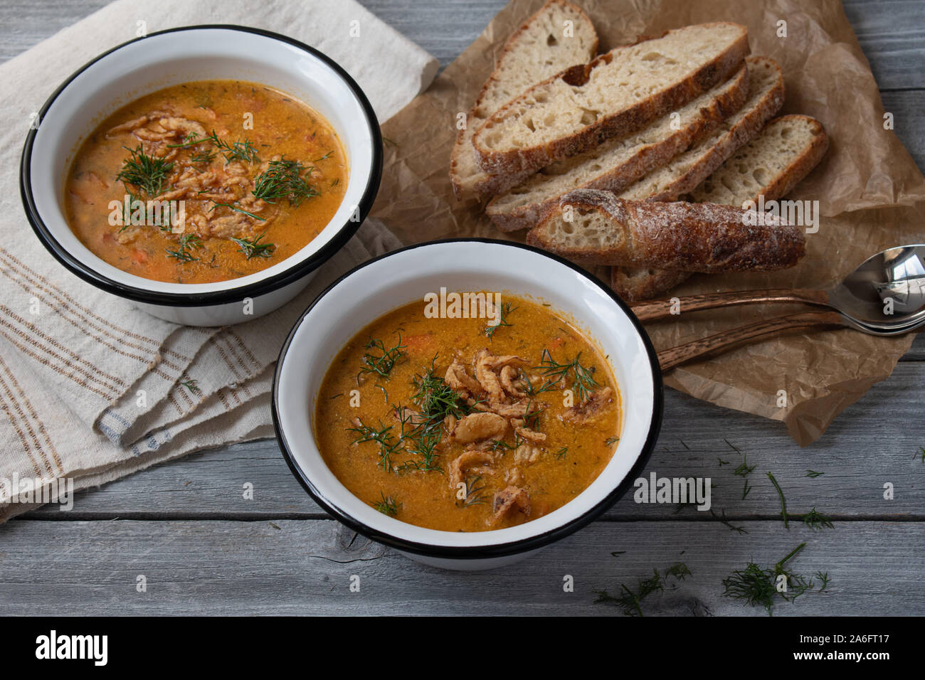 Vegan, gluten free corn grits soup with carrots and herbs, topped with crispy onions Stock Photo
