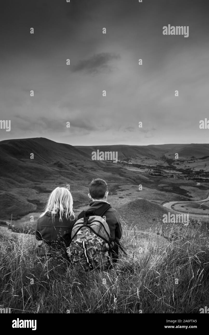 A boy with ADHD, Autism, Aspergers Syndrome, enjoys a day out hiking with his sister at the Great Ridge and Mam Tor, in the Derbyshire Peak District Stock Photo
