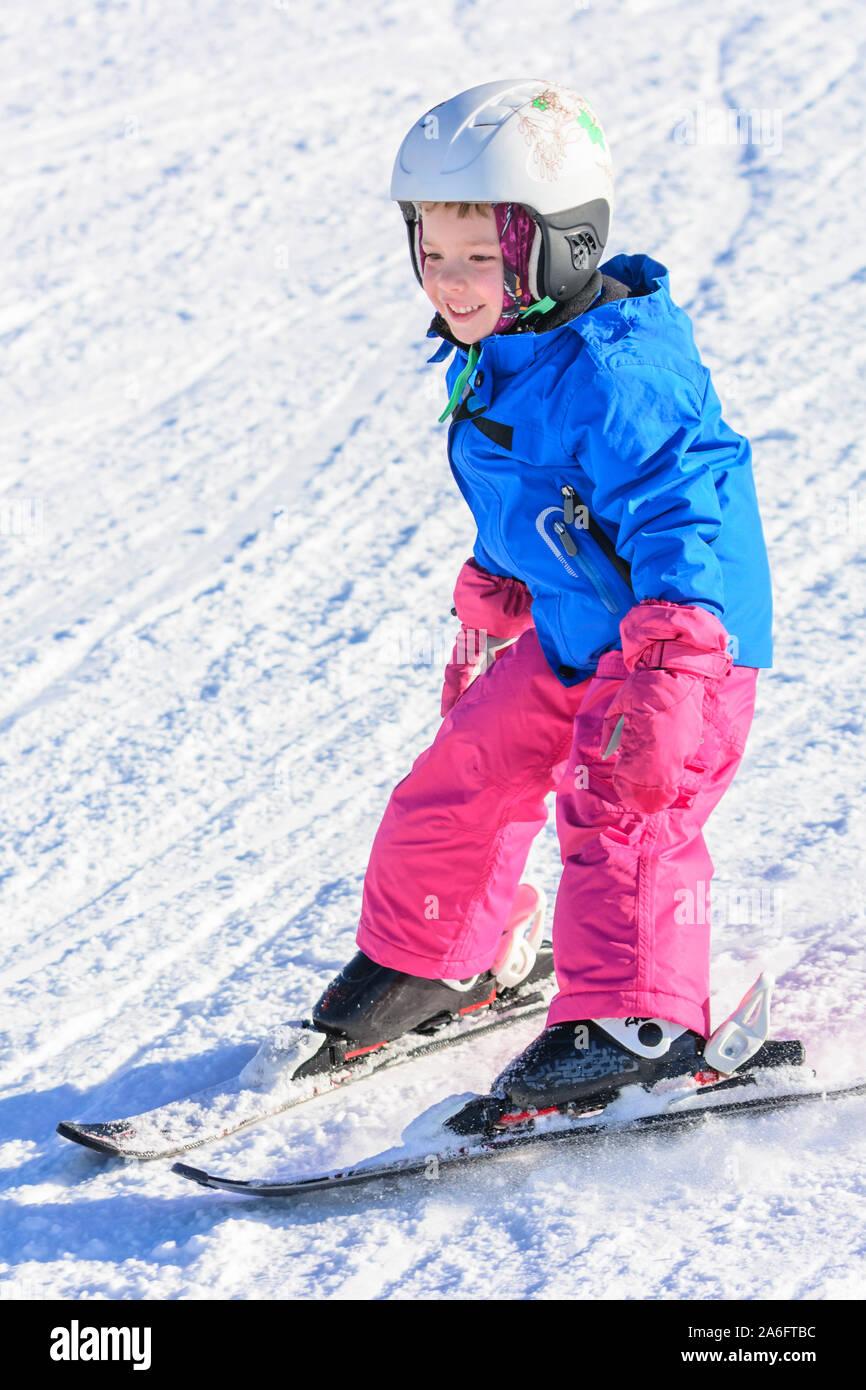 Courageous little alpine skiers on slope Stock Photo