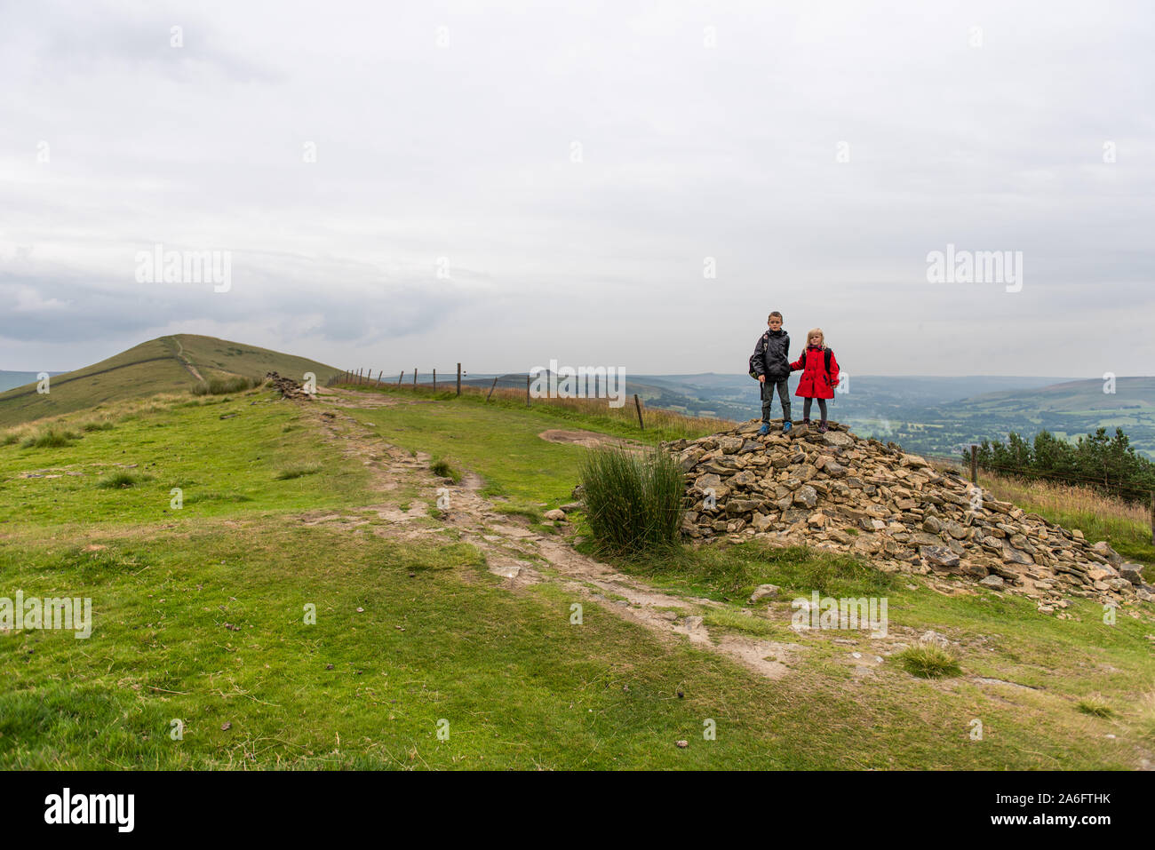 A boy with ADHD, Autism, Aspergers Syndrome, enjoys a day out hiking with his sister at the Great Ridge and Mam Tor, in the Derbyshire Peak District Stock Photo