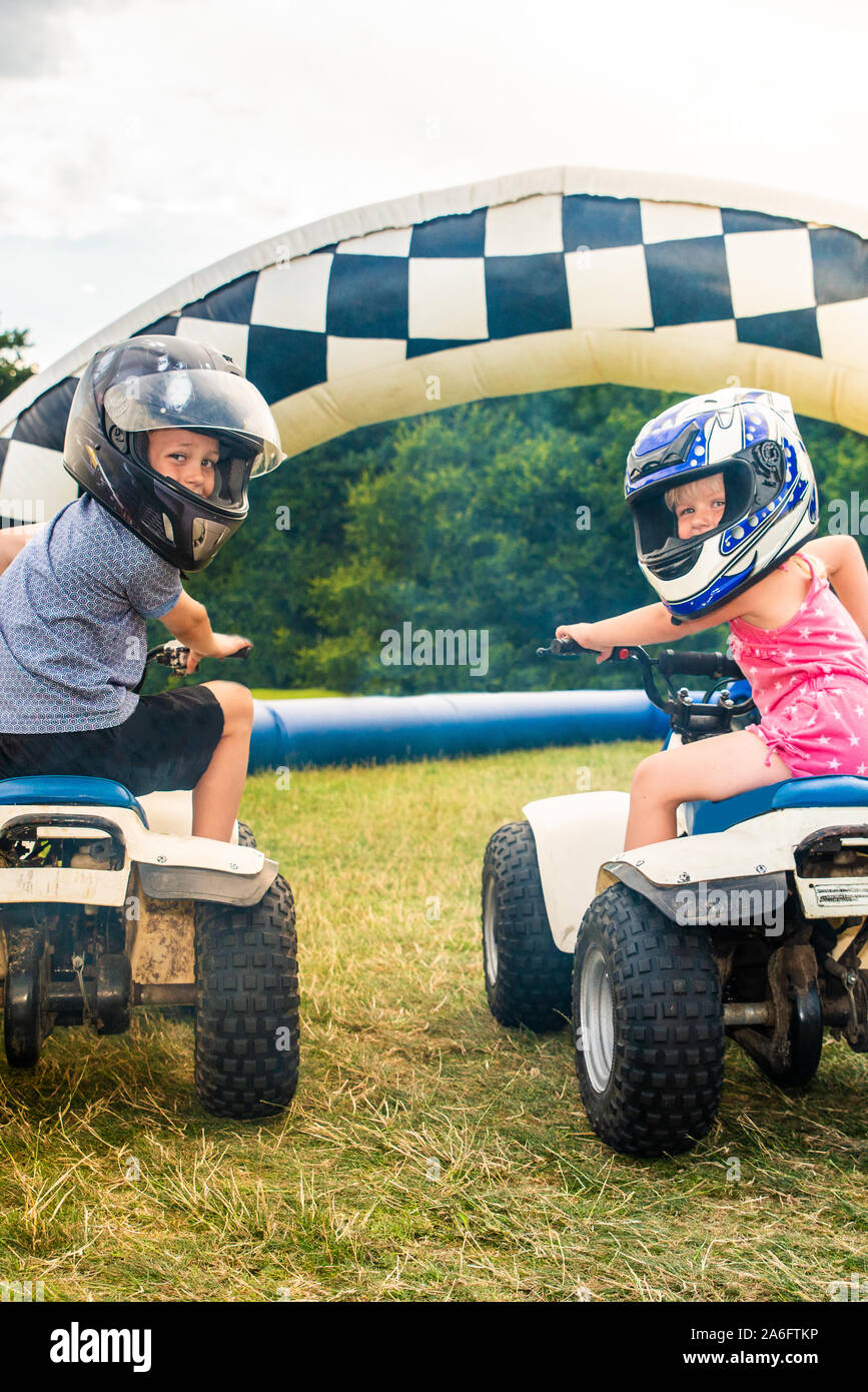 A little boy with ADHD, Autism, Aspergers Syndrome rides a quad bike with  his sister on an adventure sports day for children Stock Photo - Alamy