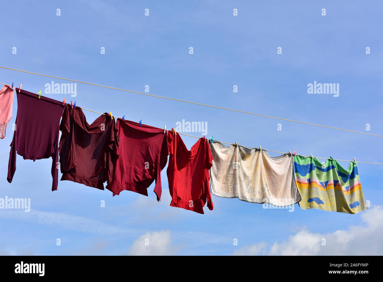 Colourful washing hanging on lines outside in fresh air to dry.  the energy efficient way of drying laundry Stock Photo