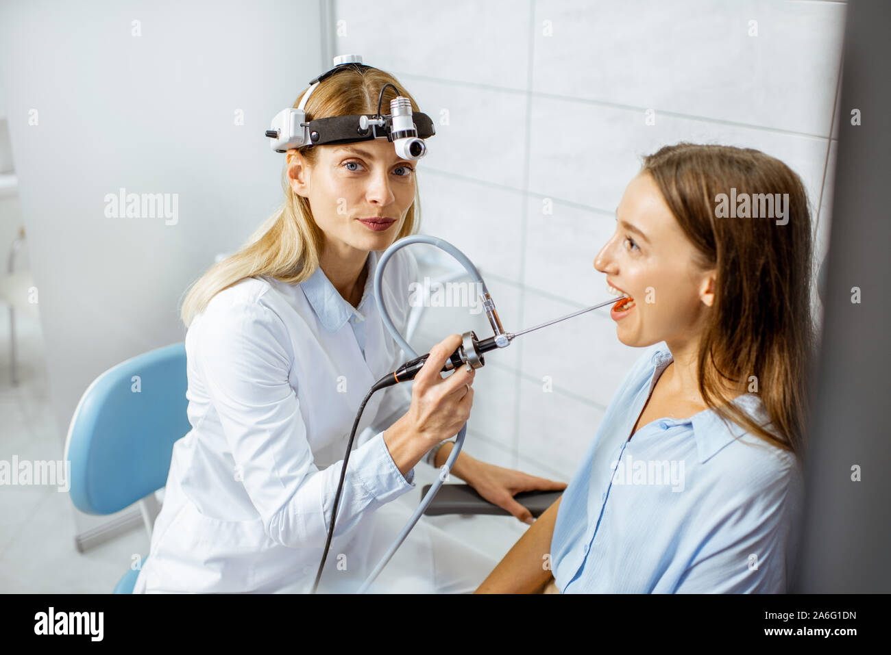 Senior otolaryngologist preparing for the endoscopic examination of ENT  organs of a young patient, holding endoscope camera in the office Stock  Photo - Alamy