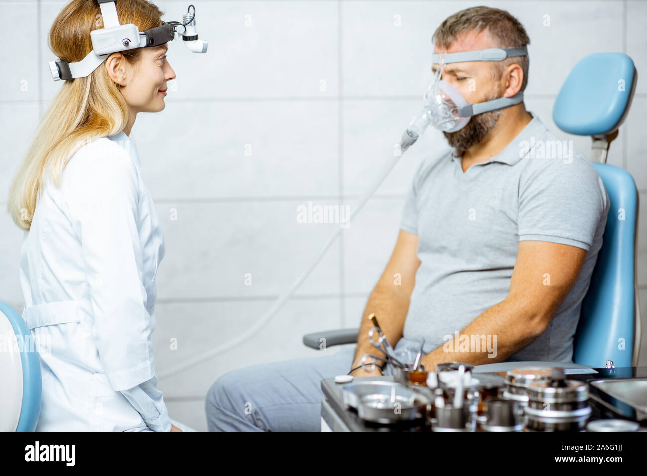 Adult man during a medical breathing treatment with respiratory mask