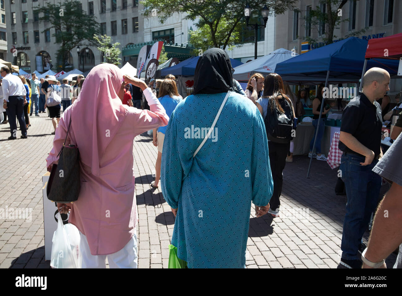 women wearing headscarfs typically islamic hijab walking round farmers market in indianapolis indiana USA Stock Photo
