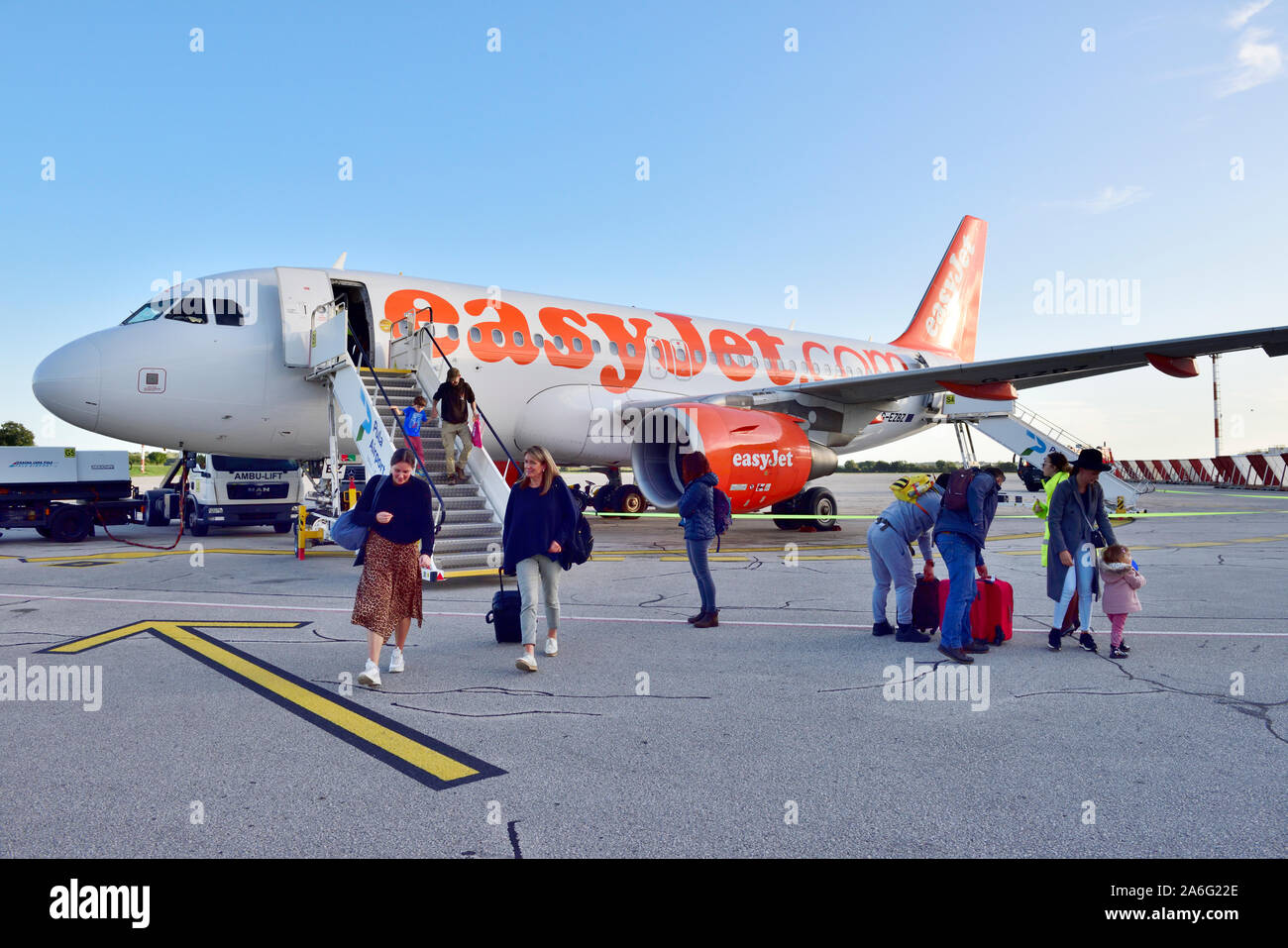 EasyJet plane with passengers disembarking at  airport using steps at front of plane Stock Photo