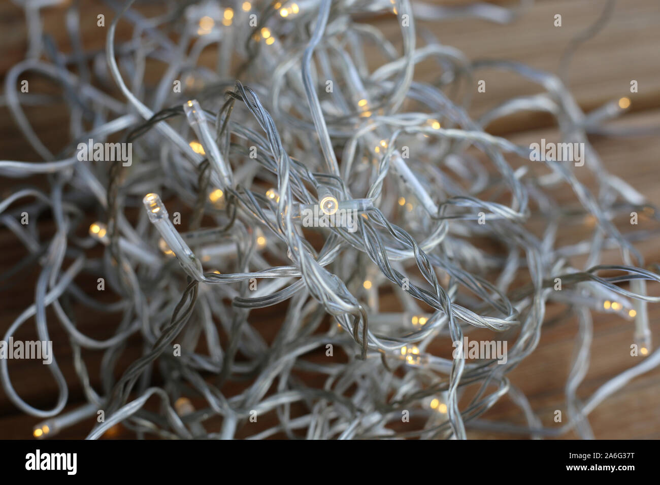 Christmas light string pile on a wooden floor. The string is