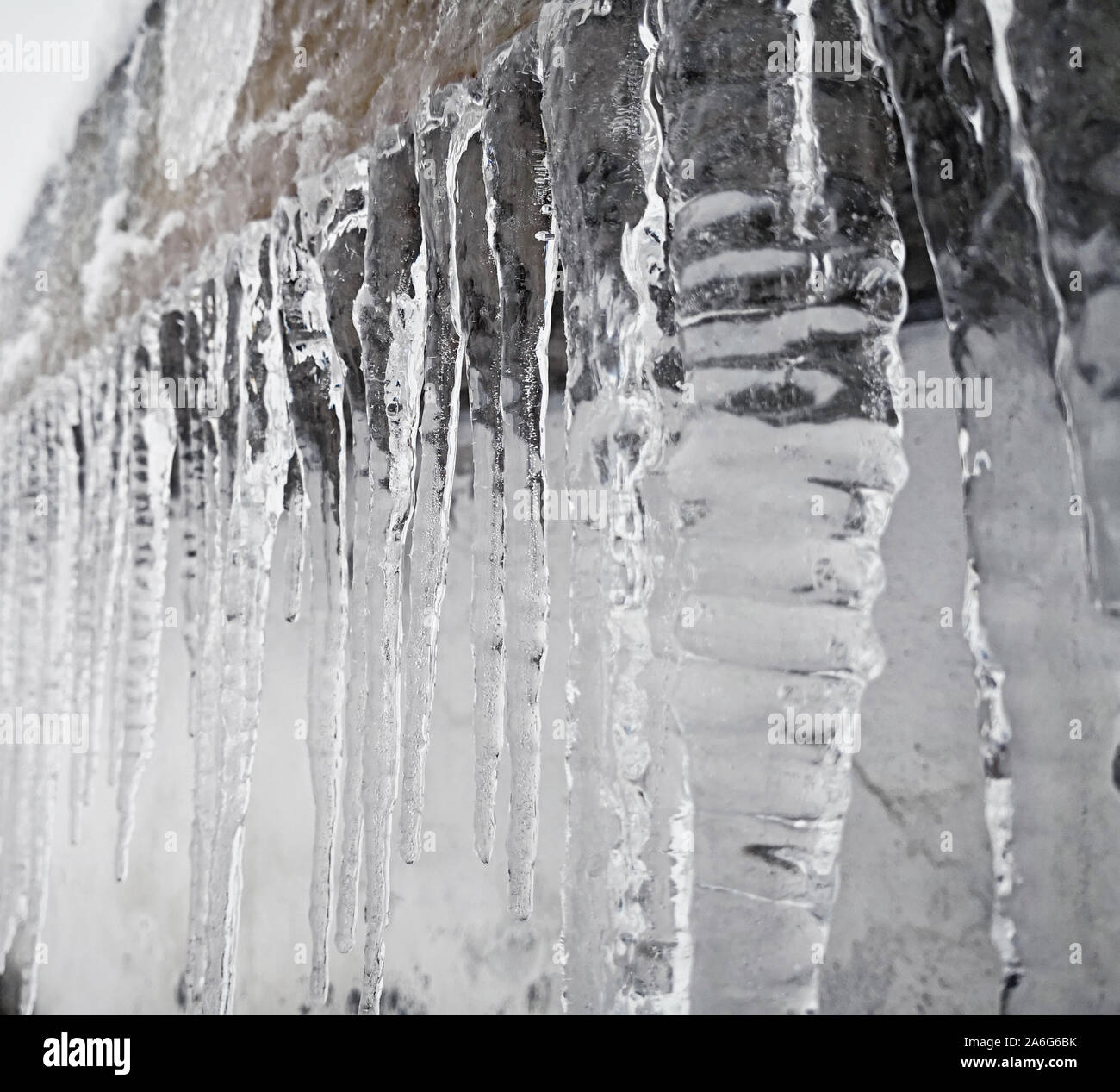 Big frosty icicles. Winter weather warnings. Stock Photo