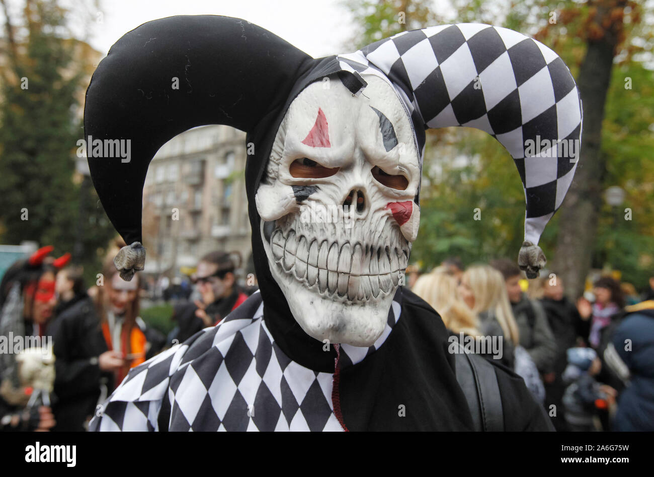 A participant wearing make-up and zombie costume attends the Halloween parade in Kiev.Hundreds of zombies staggered through the inner city in search of fresh brains during the Halloween Parade. Halloween is a holiday celebrated in the world on 31 October, the eve of the Western Christian feast of All Hallows' Day in which participants attend the Halloween costume parties, carving pumpkins into jack-o'-lanterns, lighting bonfires, apple bobbing, playing pranks, tell scary stories and watch horror films. Stock Photo