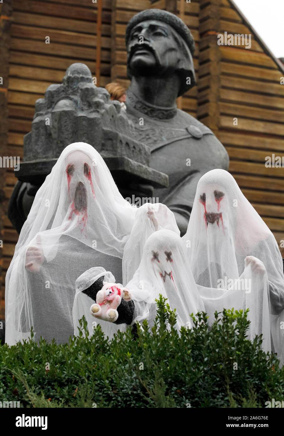 A family wearing ghost costumes attend the Zombie Walk in Kiev.Hundreds of zombies staggered through the inner city in search of fresh brains during the Halloween Parade. Halloween is a holiday celebrated in the world on 31 October, the eve of the Western Christian feast of All Hallows' Day in which participants attend the Halloween costume parties, carving pumpkins into jack-o'-lanterns, lighting bonfires, apple bobbing, playing pranks, tell scary stories and watch horror films. Stock Photo