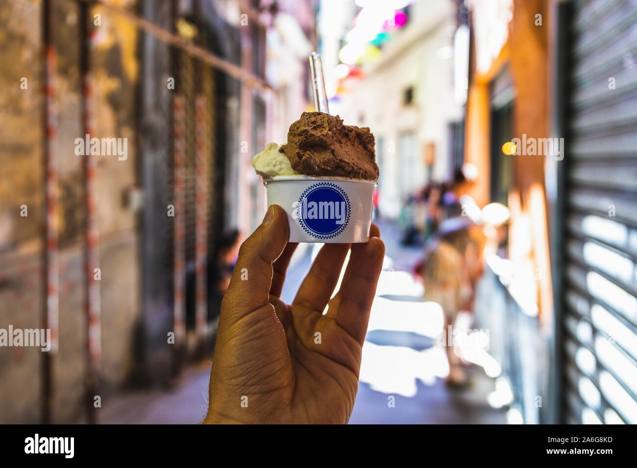 Human hand holding a cup of Italian ice cream with copy space on cup