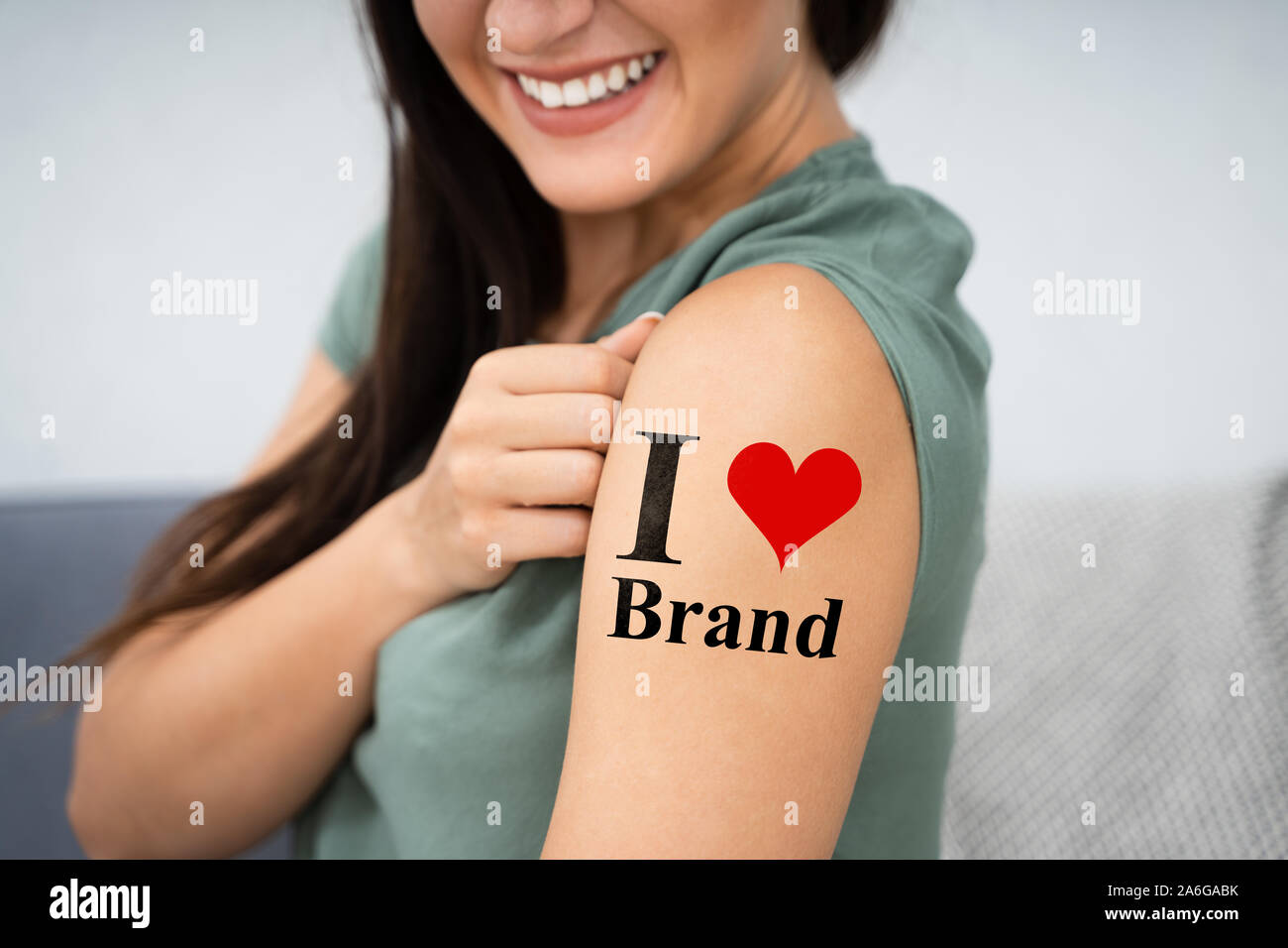 Woman Showing Her I Love Brand Tattoo Stock Photo