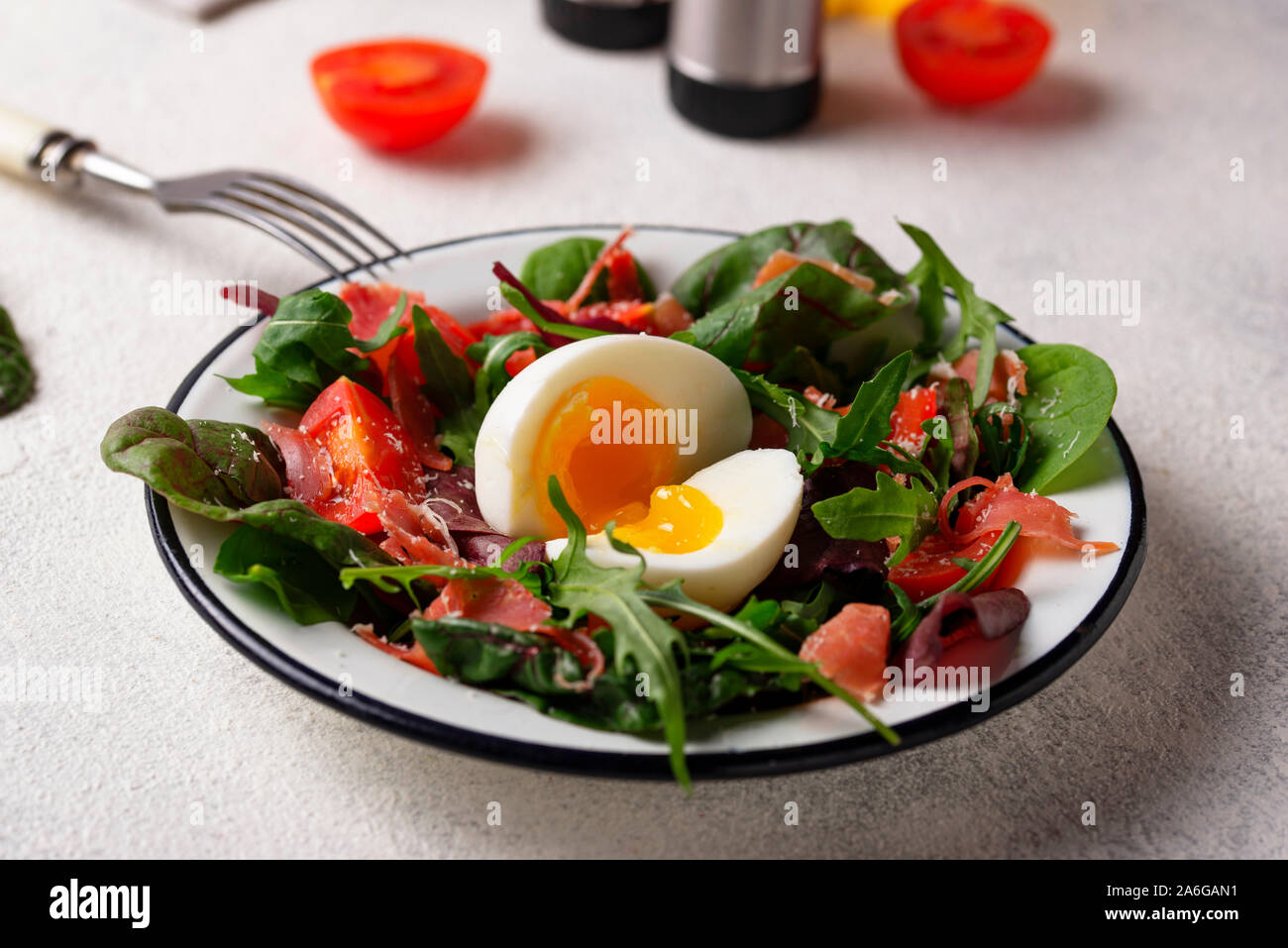 Healthy salad with prosciutto, tomato and egg Stock Photo Alamy