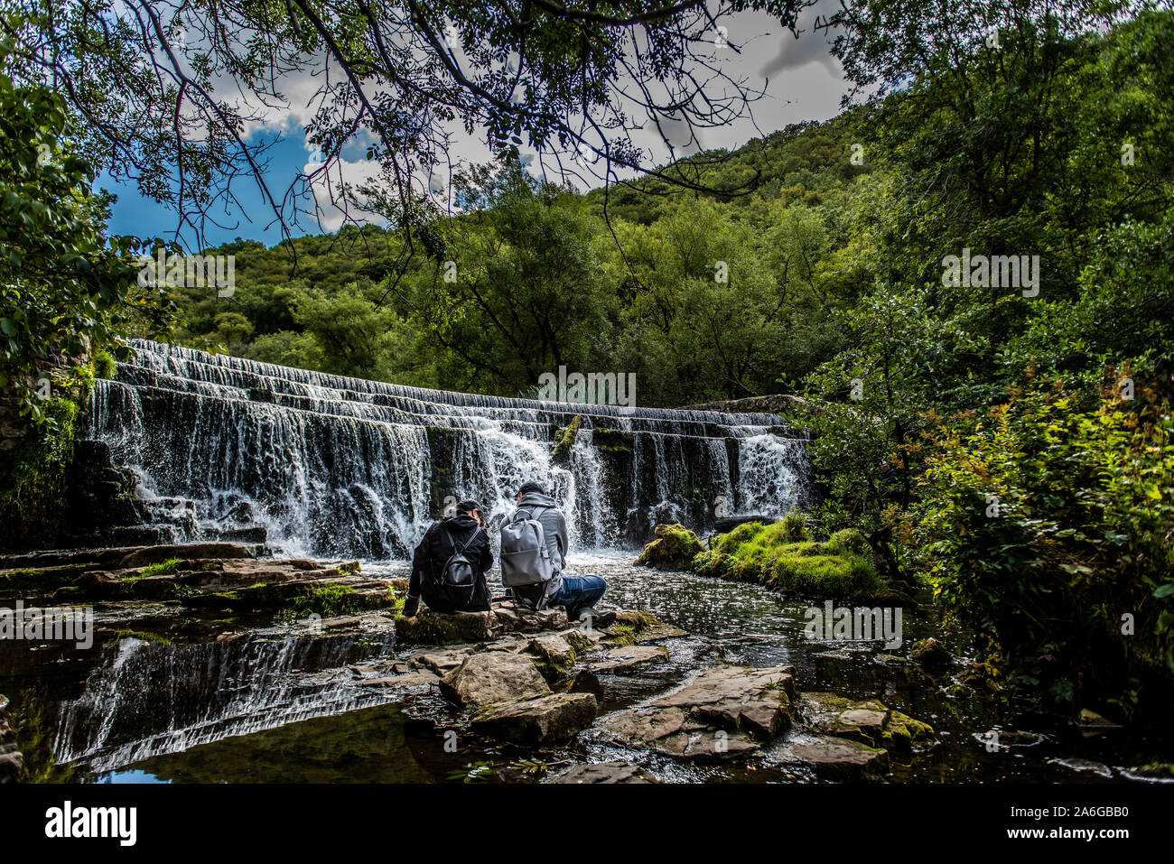 Landscape Photographers & tourists taking pictures of a waterfall in the Peak District National Park, Bakewell Stock Photo