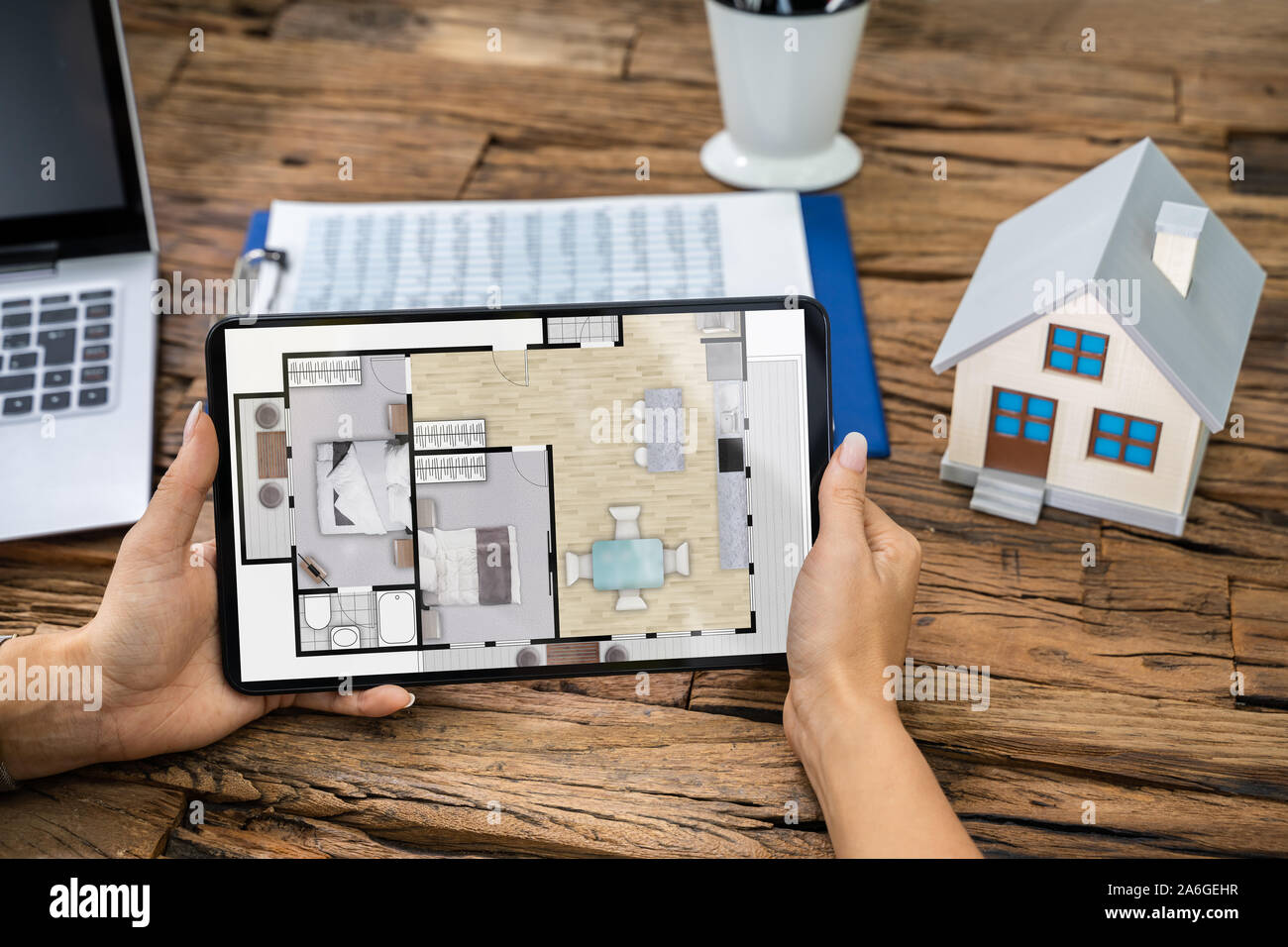 Architect Analyzing House Floor Plan On Digital Tablet Stock Photo