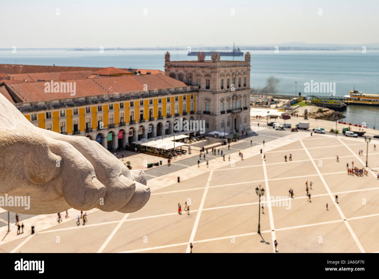 Gigantic toes and foot of allegorical sculpture atop the Arco da Rua Augusta overlooking the Praça do Comércio in Baixa, Lisbon City Centre. Stock Photo