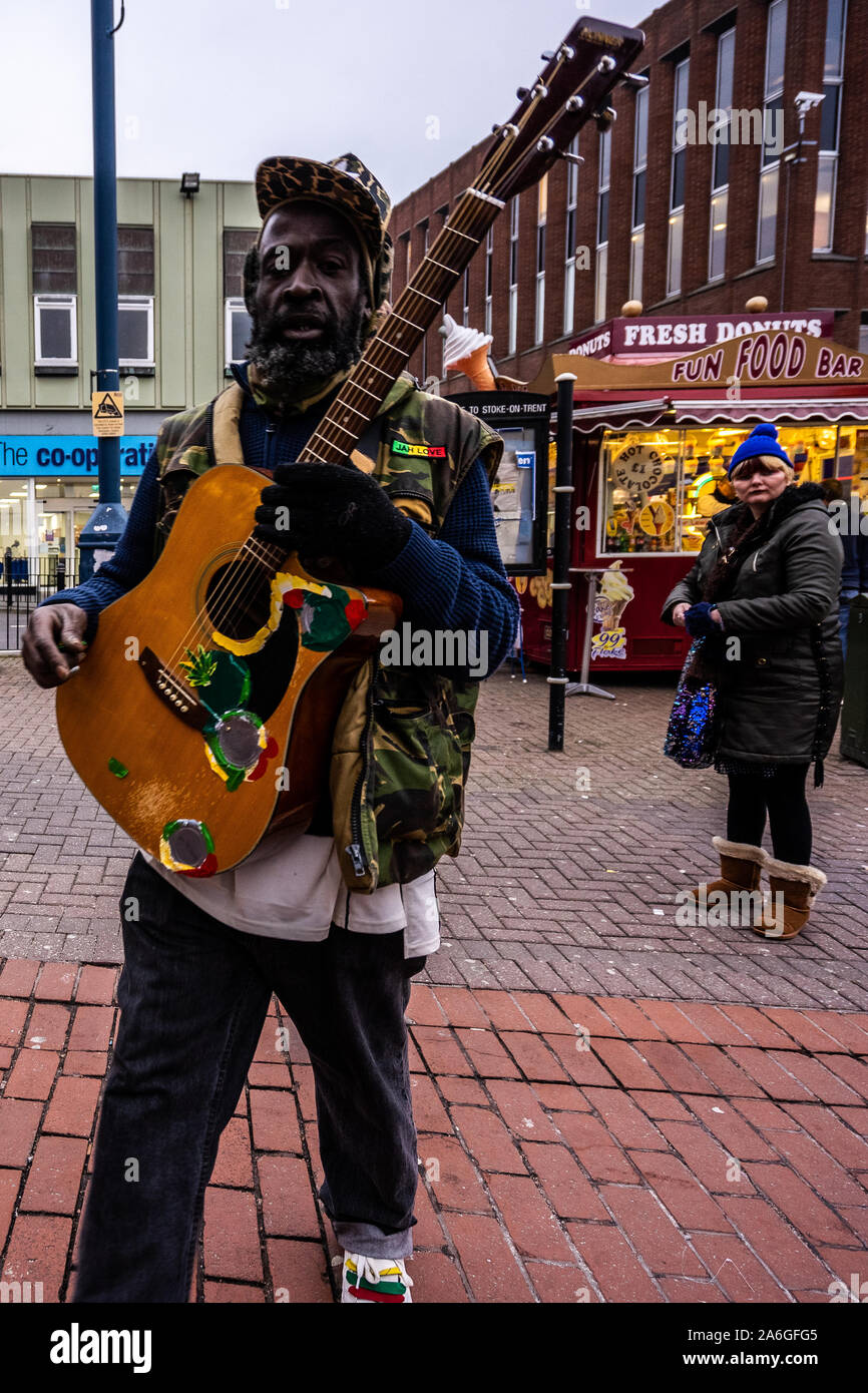 A homeless man busting for money on the high street Stock Photo