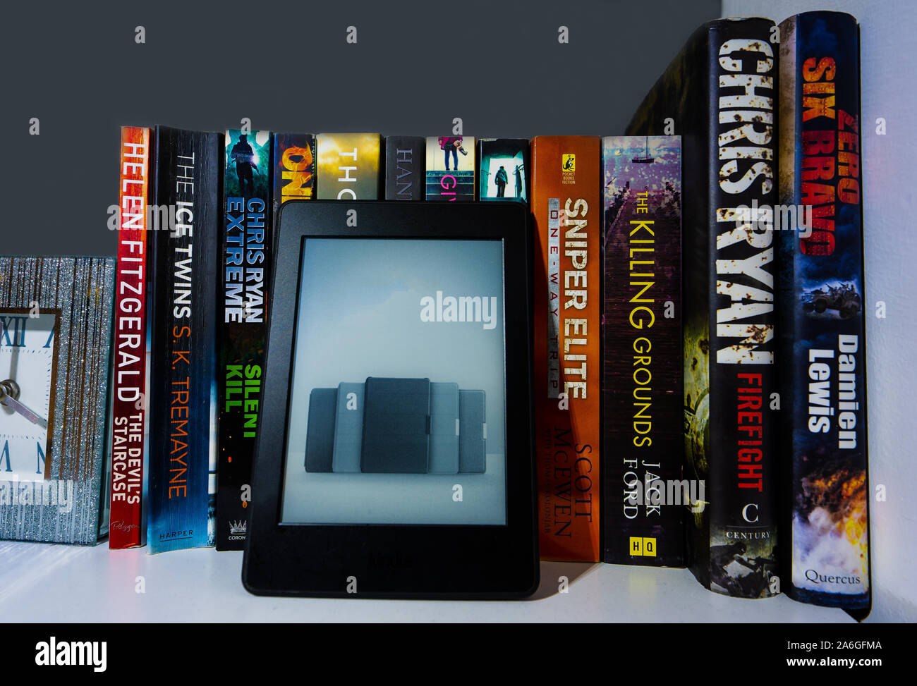 An Ereader Kindle Full Of Ebooks On A Bookshelf Surrounded By