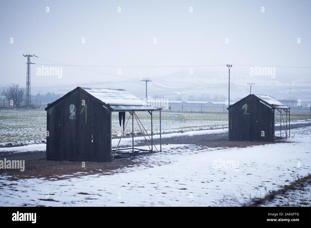 depressing scenery. countryside with wood huts on winter day Stock Photo
