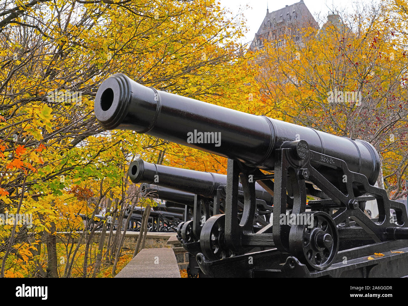 Cannons on wall of Old Quebec City with Chateau Frontenac in background in autumn. Stock Photo