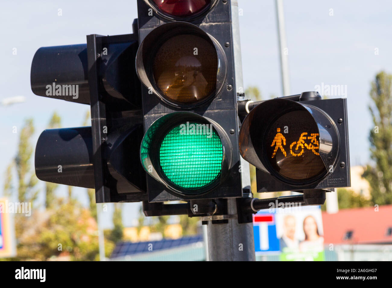 Traffic lights showing green with additional warning light of pedestrians and cyclists Stock Photo