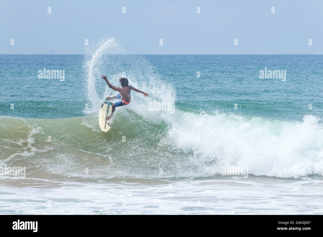 Hikkaduwa, Sri Lanka - 10/18/2019 - Pro surfer surfing at the Sri Lanka beach Stock Photo