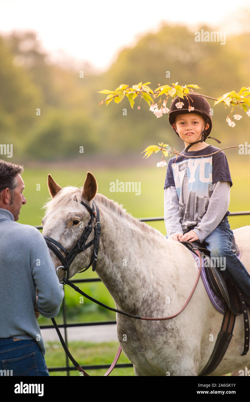 A little boy with Autism, ADHD, Aspergers Syndrome, riding a horse with