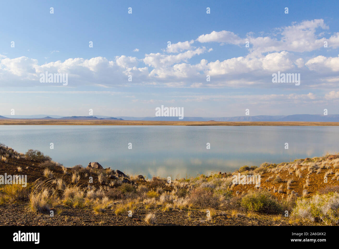 Clouds are softly reflected in the reservoir in Tankwa Karoo, South Africa Stock Photo