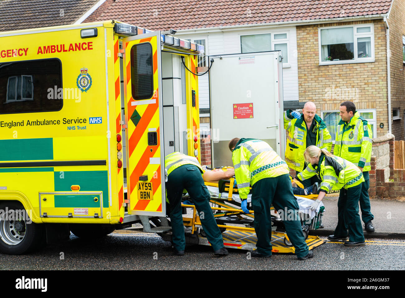 Emergency services on scene at a drink driving accident with an over turned and injured driver, Police, ambulance paramedics and fire brigade, Police Stock Photo