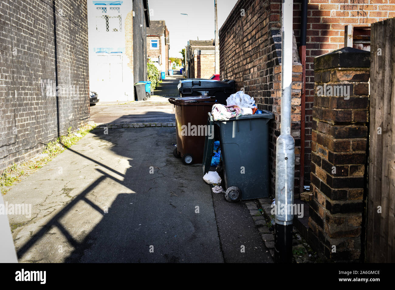 Discarded rubbish and overflowing bins in the back streets of Fenton