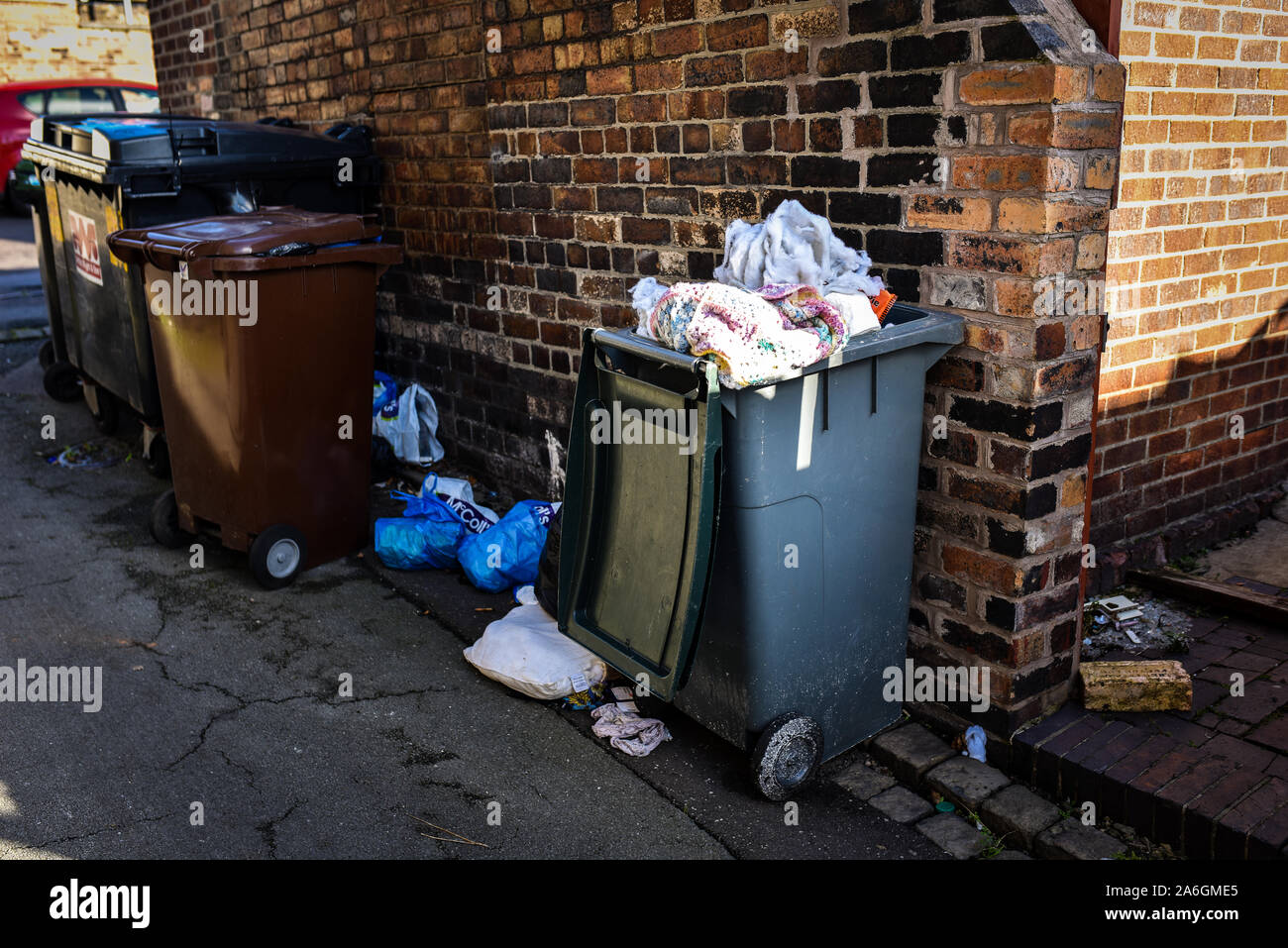 Discarded rubbish and overflowing bins in the back streets of Fenton