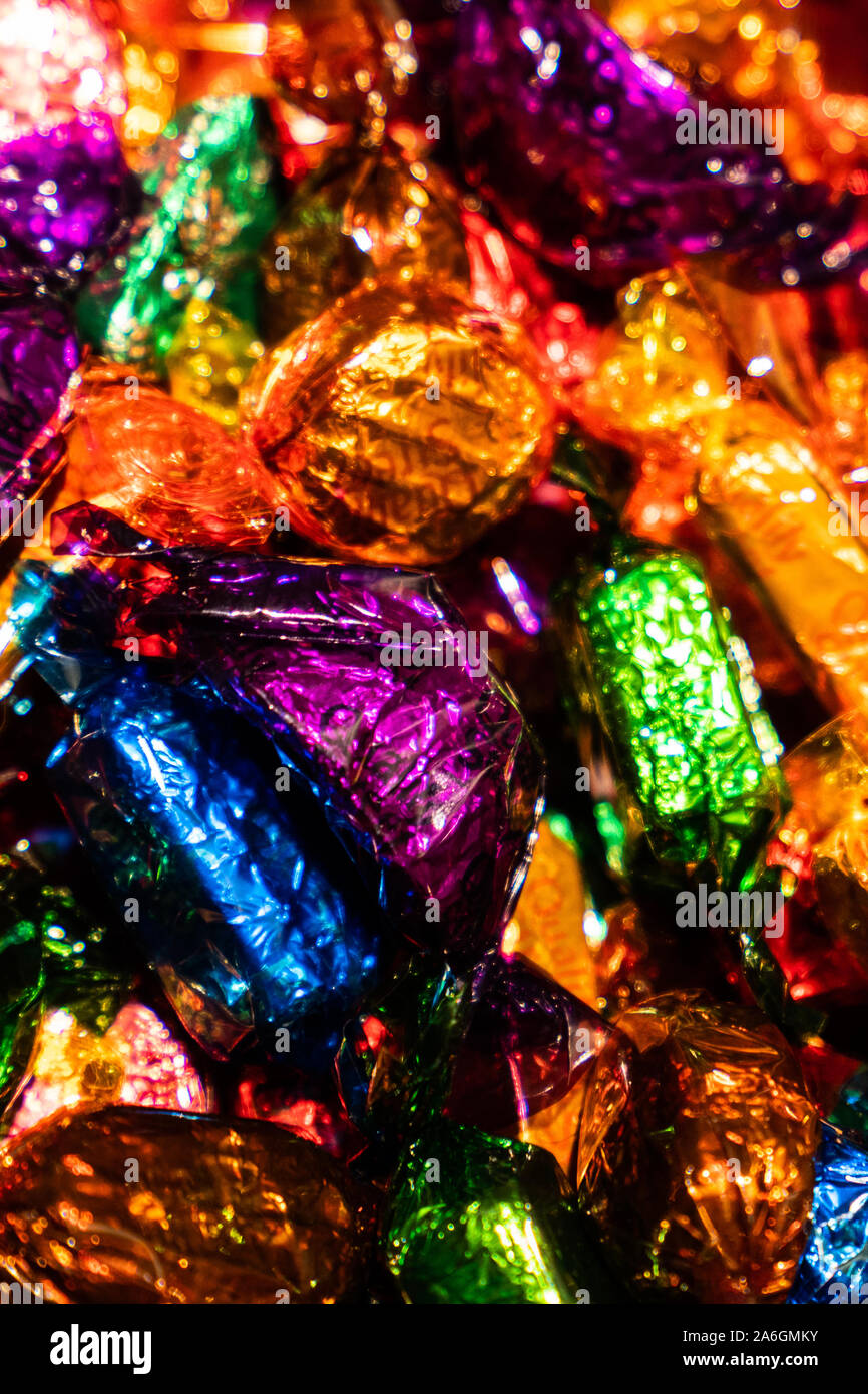 A selection of quality street chocolates in a tin ready to be eaten, Christmas time, festive treats Stock Photo
