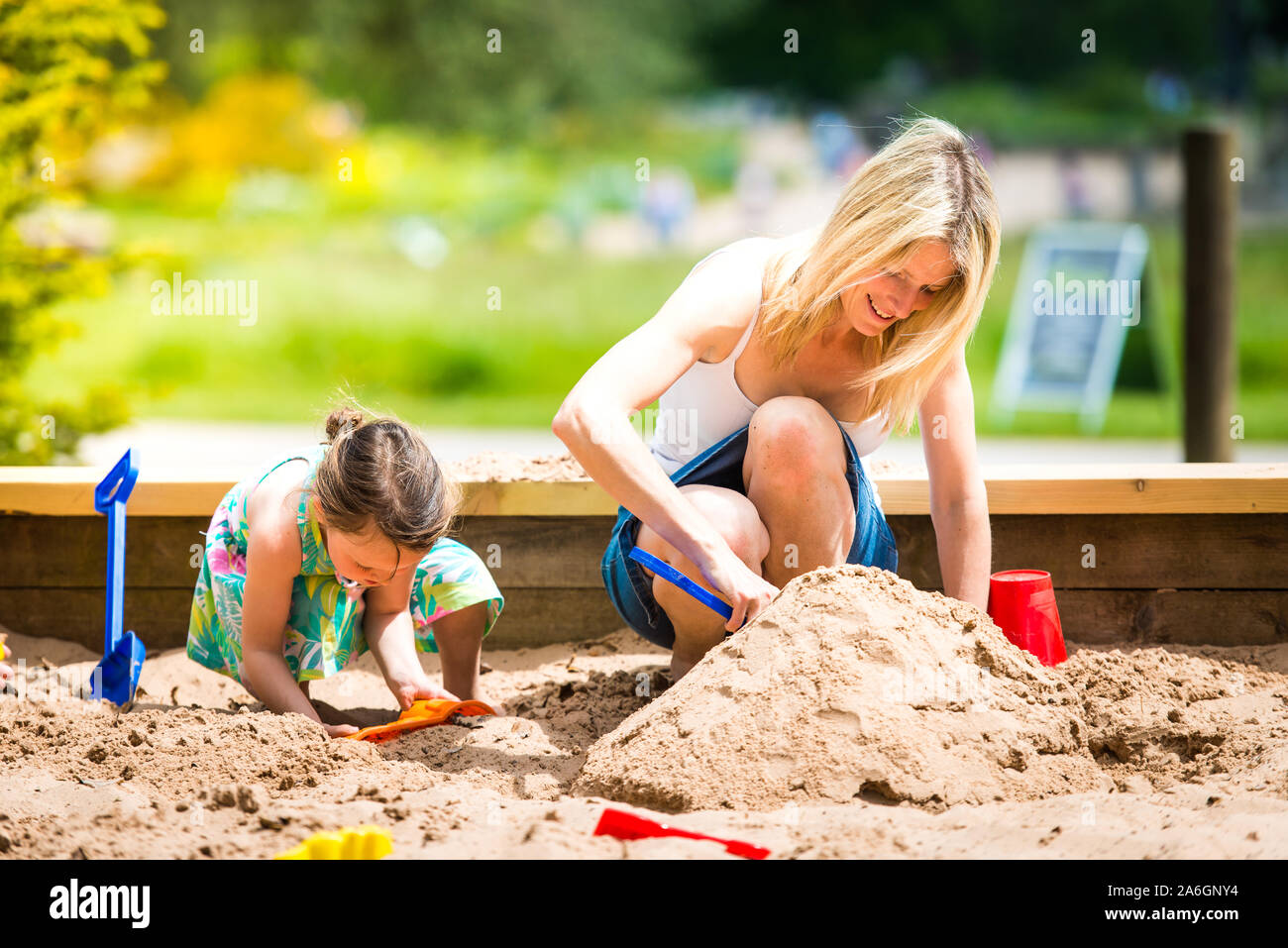 A pretty mother in her 40's cuddles playing with her daughter at the