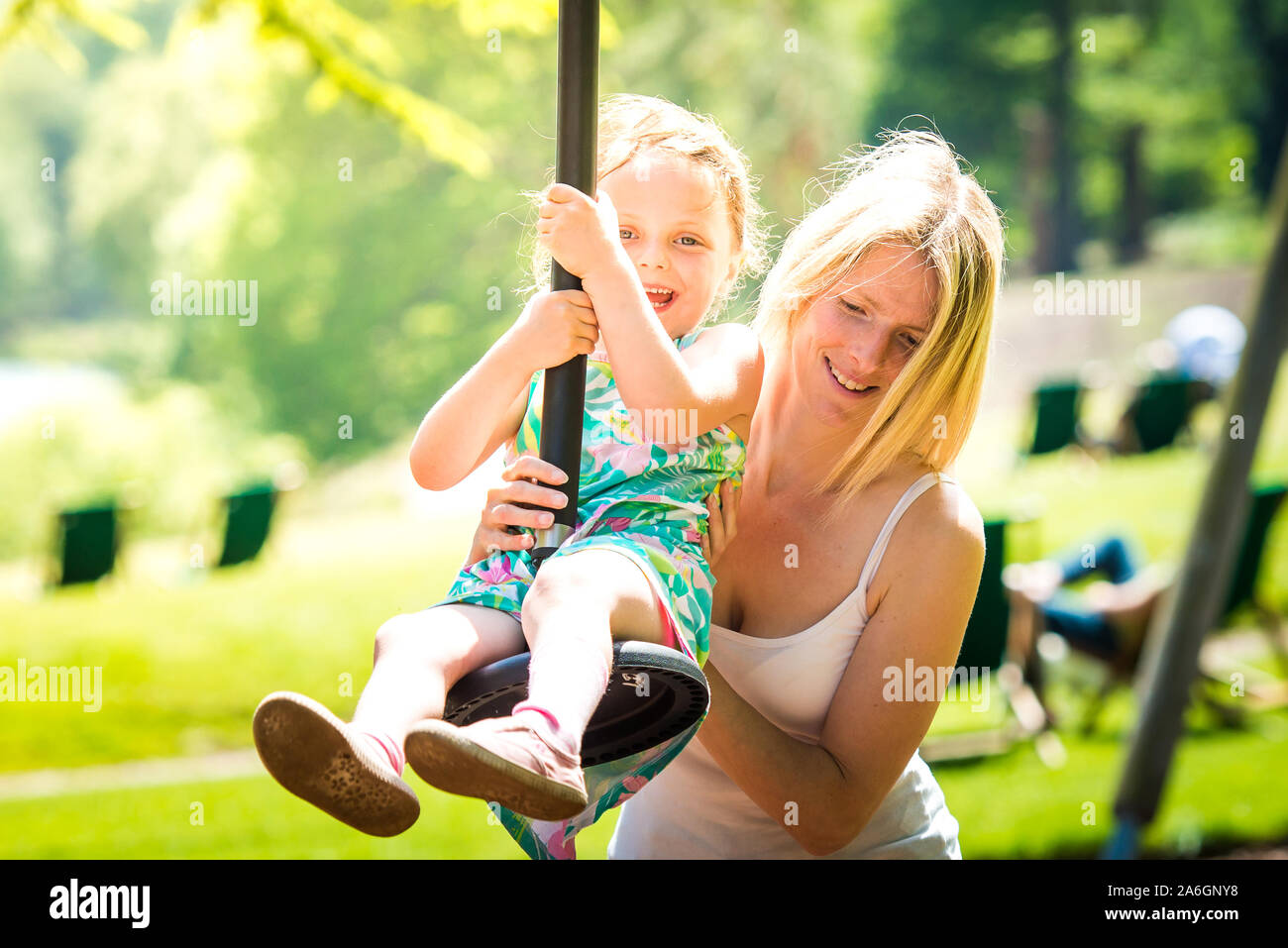 A pretty mother in her 40's cuddles playing with her daughter at the