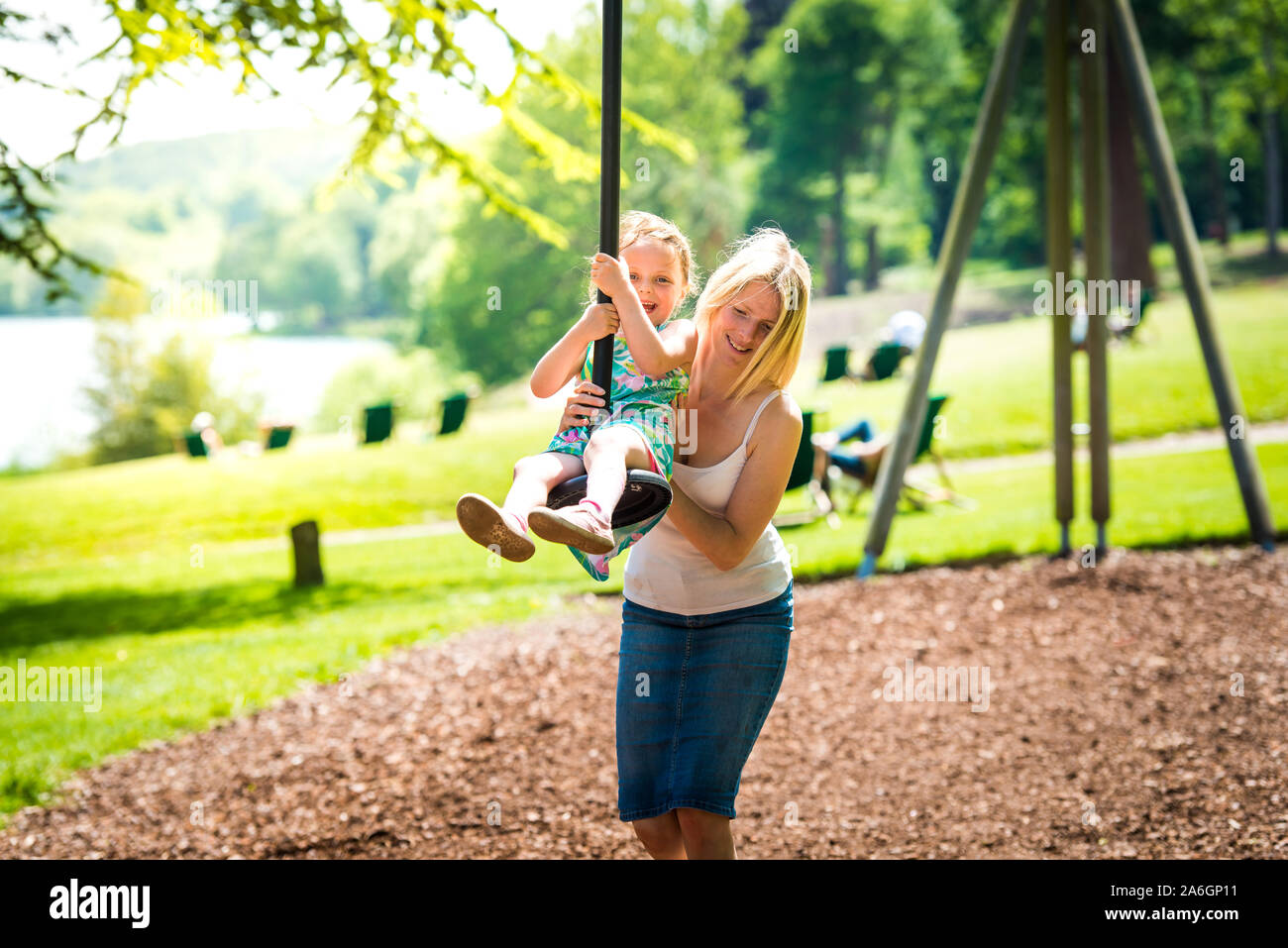A pretty mother in her 40's cuddles playing with her daughter at the
