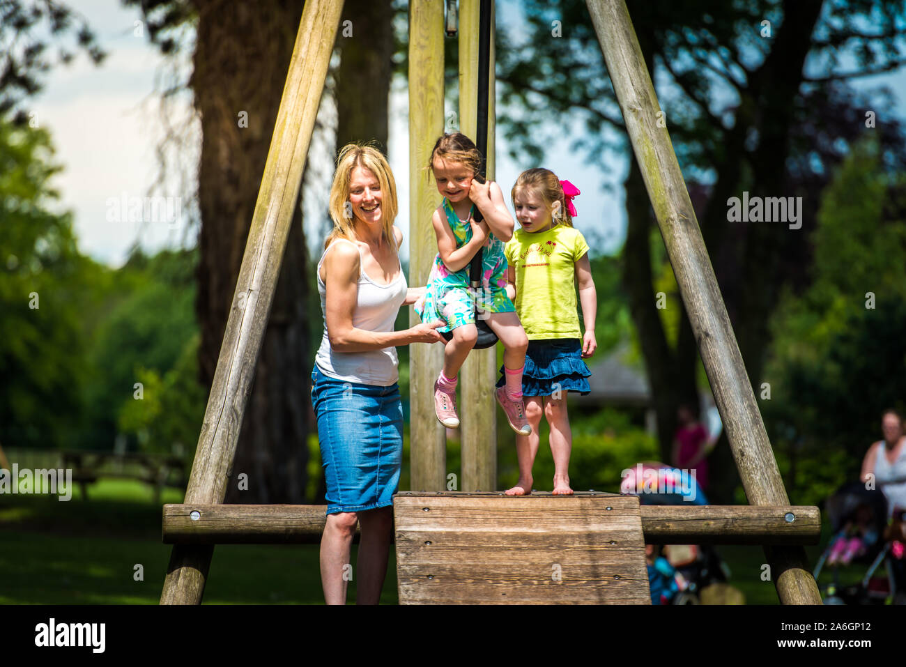 A pretty mother in her 40's cuddles playing with her daughter at the