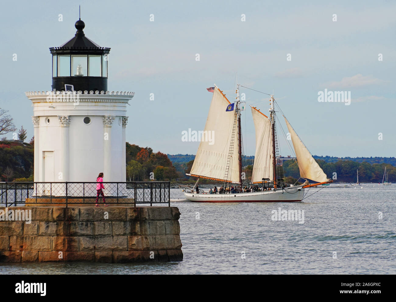 Portland Schooner Company's historic schooner Timberwind on sightseeing cruise passing Bug Light at Portland, Maine, USA. Stock Photo