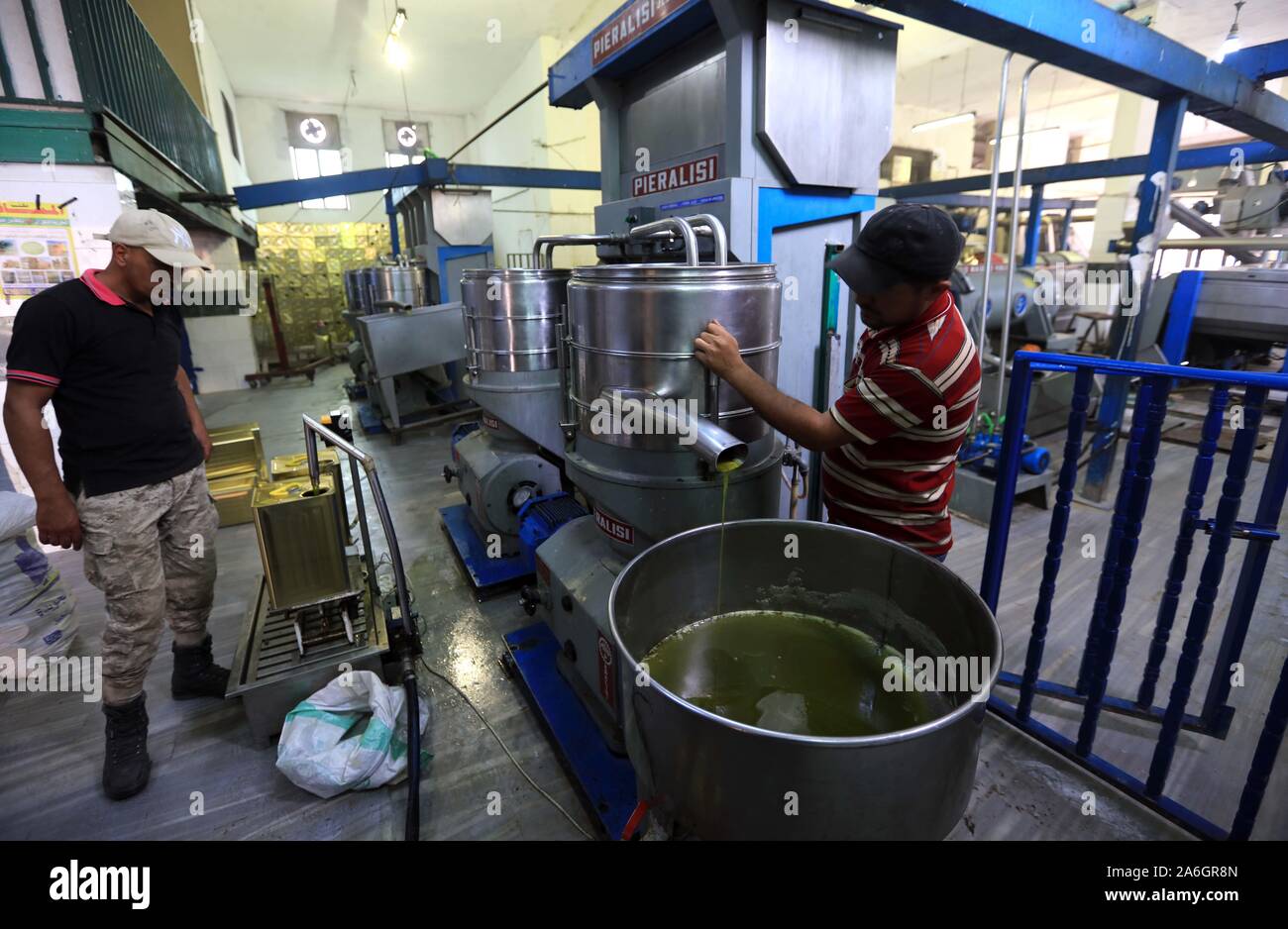 (191026) -- AJLOUN (JORDAN), Oct. 26, 2019 (Xinhua) -- Workers are seen at an olive oil processing factory in Ajloun, north of Amman, Jordan, on Oct. 26, 2019. Jordan's Ministry of Agriculture has decided not to allow the export of olives this year in order to provide sufficient quantities for the local market in the olive season, which usually starts in mid-October, said the ministry in a statement. (Photo by Mohammad Abu Ghosh/Xinhua) Stock Photo