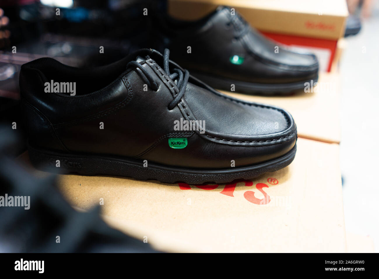 Boys and girls Kickers School shoes, footwear held by a man and on sale  before the new school year starts Stock Photo - Alamy