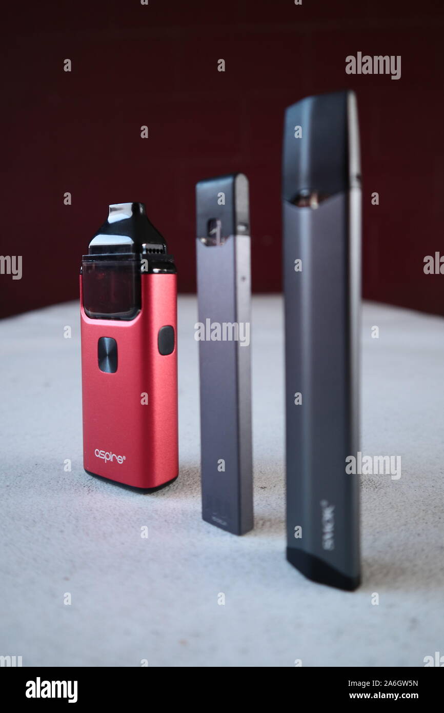 3 different vape pen electronic cigarette devices juul, aspire breeze, smok infinix, product shot isolated Stock Photo